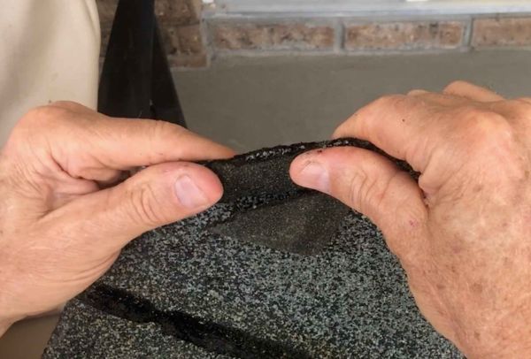 Person holding an oil stick